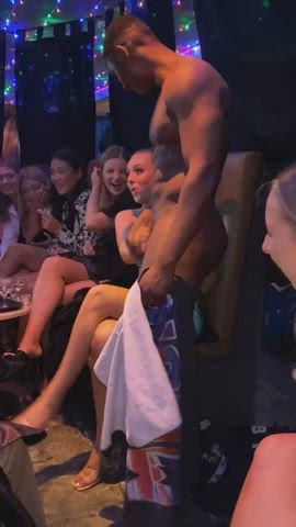 Woman giving male stripper a tug behind the towel - free porn video
