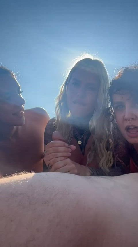 Guy getting his dicked sucked by 3 girls on the beach. - free porn video